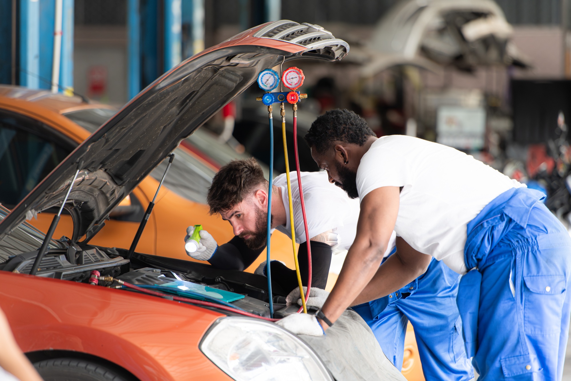 car-mechanic-working-in-an-auto-repair-shop-inspecting-the-operation-of-the-car-s-air-conditioner.jpg car-mechanic-working-in-an-auto-repair-shop-inspecting-the-operation-of-the-car-s-air-conditioner.jpg