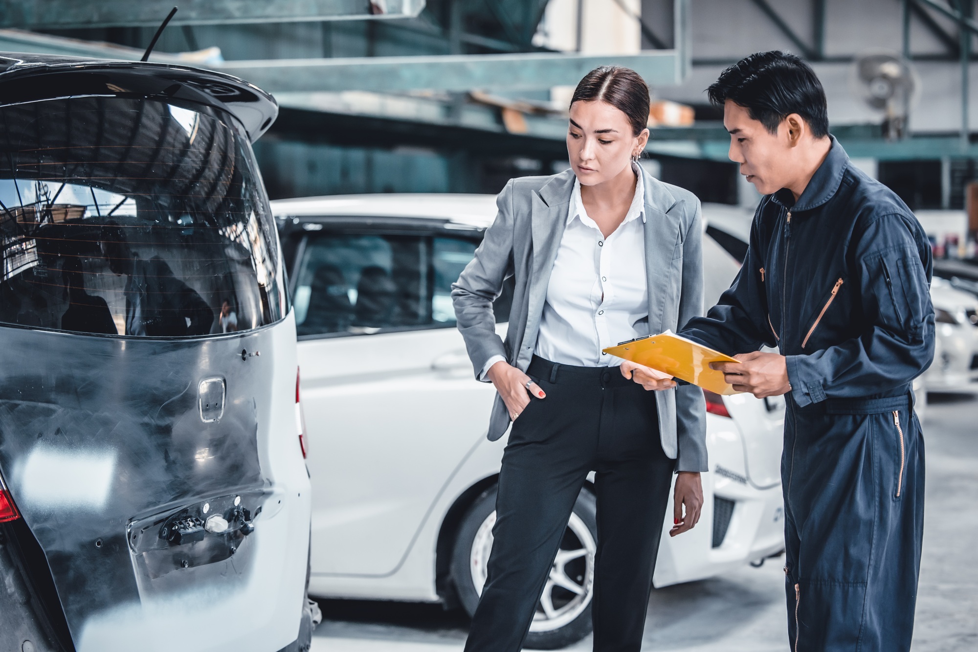 mechanic-working-in-a-car-repair-shop-is-estimating-the-damage-and-cost-of-repairs-with-car-owner-.jpg mechanic-working-in-a-car-repair-shop-is-estimating-the-damage-and-cost-of-repairs-with-car-owner-.jpg